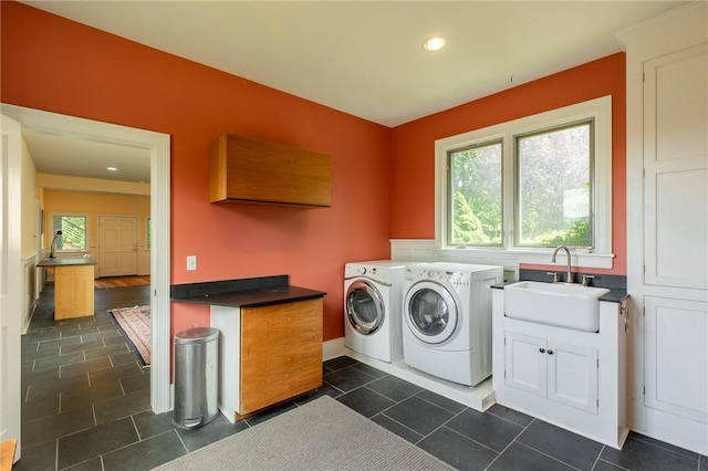 laundry room with cabinets, washing machine and dryer, a wealth of natural light, and sink