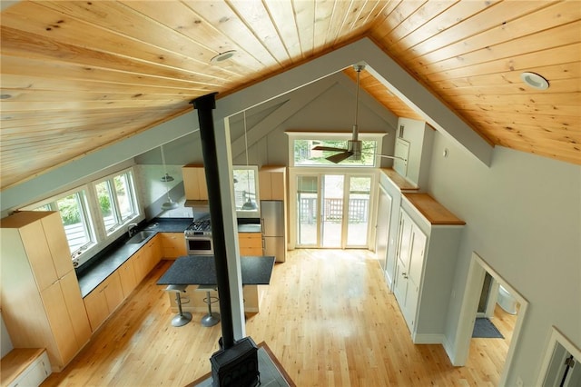 bonus room featuring ceiling fan, sink, wooden ceiling, lofted ceiling, and light wood-type flooring