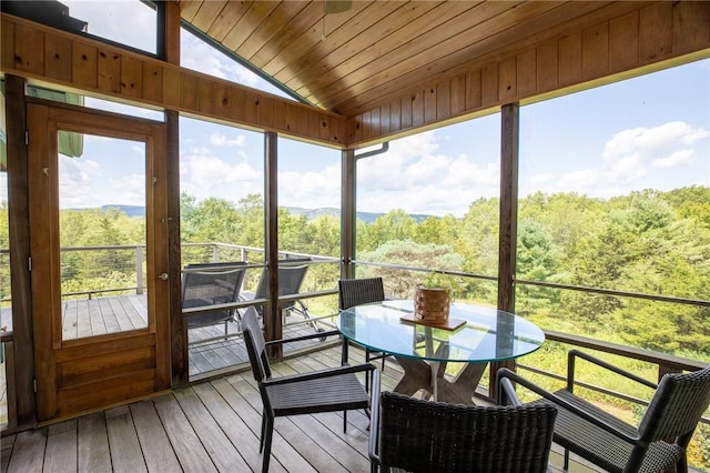 sunroom featuring wooden ceiling and vaulted ceiling