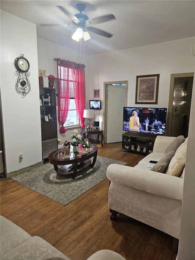 living room with wood-type flooring and ceiling fan