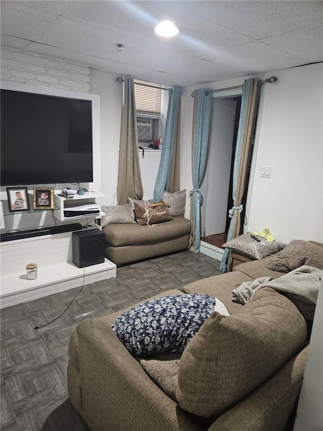 living room featuring cooling unit and dark parquet flooring