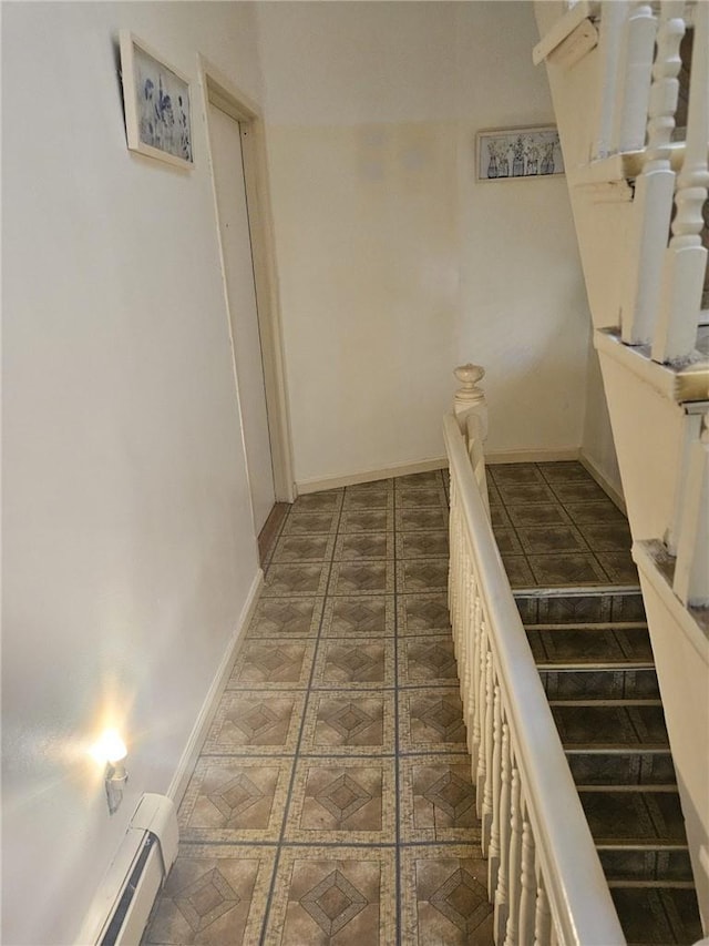 staircase featuring tile patterned flooring and a baseboard radiator