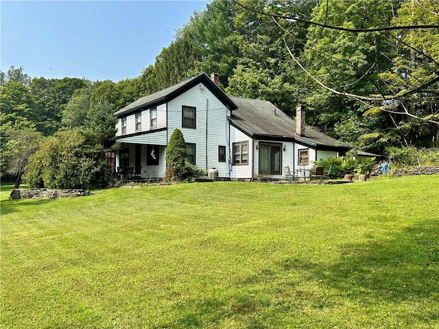 rear view of property featuring a yard