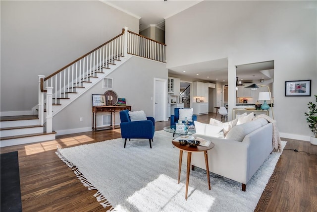 living room featuring hardwood / wood-style flooring and a towering ceiling