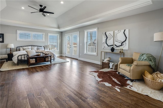 bedroom with dark hardwood / wood-style floors, ceiling fan, a raised ceiling, and access to outside