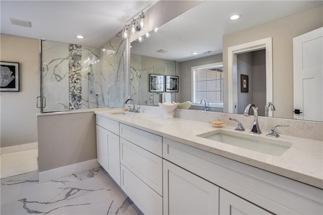 bathroom with vanity and a shower with door