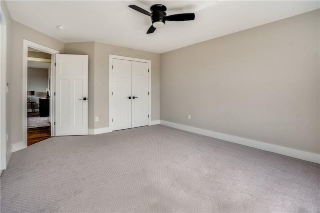 unfurnished bedroom featuring ceiling fan, carpet floors, and a closet