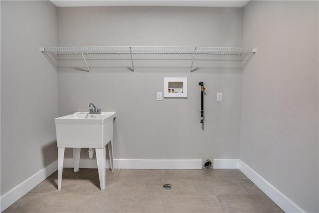 washroom with light tile patterned flooring, gas dryer hookup, and hookup for a washing machine