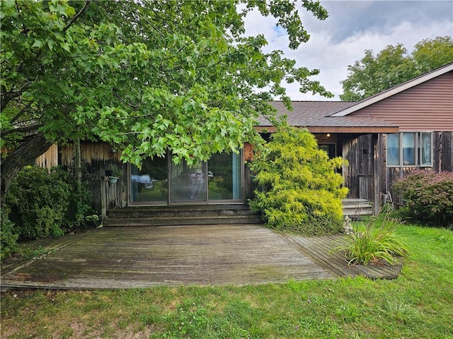 rear view of house featuring a yard and a wooden deck