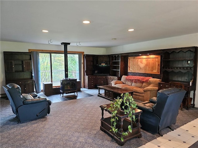 living room with a wood stove and carpet floors