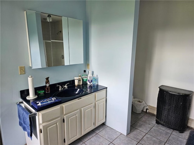 bathroom featuring tile patterned floors, vanity, and an enclosed shower