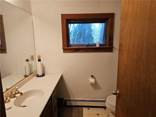 bathroom with tile patterned flooring, vanity, a baseboard radiator, and toilet