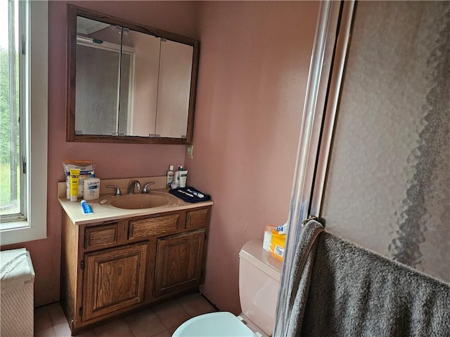 bathroom featuring tile patterned floors, vanity, and toilet