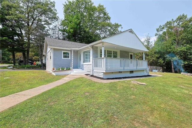 view of front facade with covered porch and a front yard