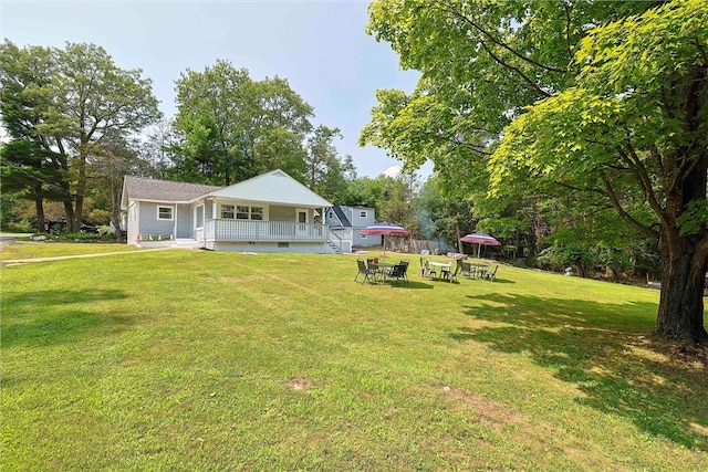 view of yard featuring covered porch