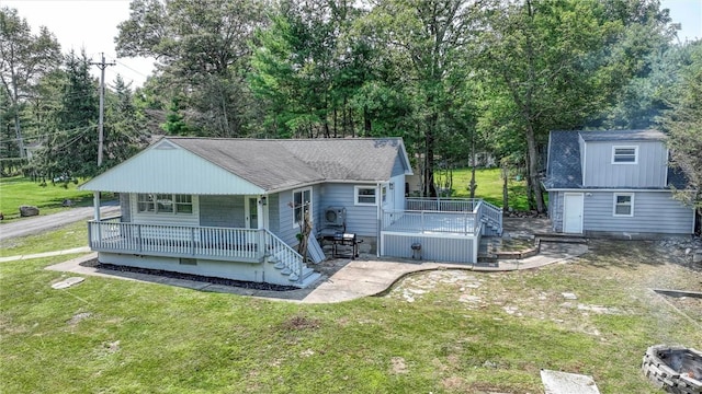 back of property featuring covered porch and a yard