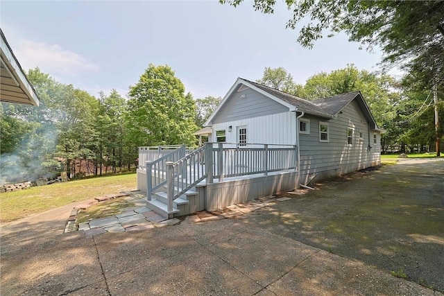 view of home's exterior with a wooden deck