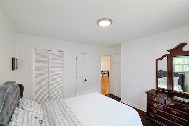 bedroom featuring dark hardwood / wood-style flooring and a closet