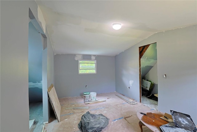 spare room featuring lofted ceiling