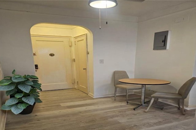 dining room featuring light wood-type flooring and electric panel