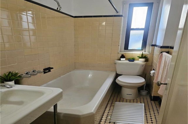 full bathroom with tile patterned floors, sink, tile walls, toilet, and tiled shower / bath