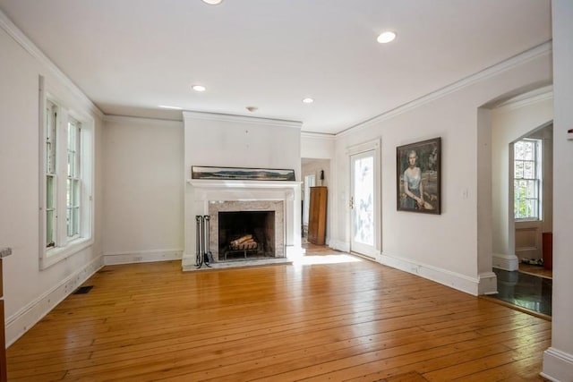 unfurnished living room with light hardwood / wood-style flooring and ornamental molding