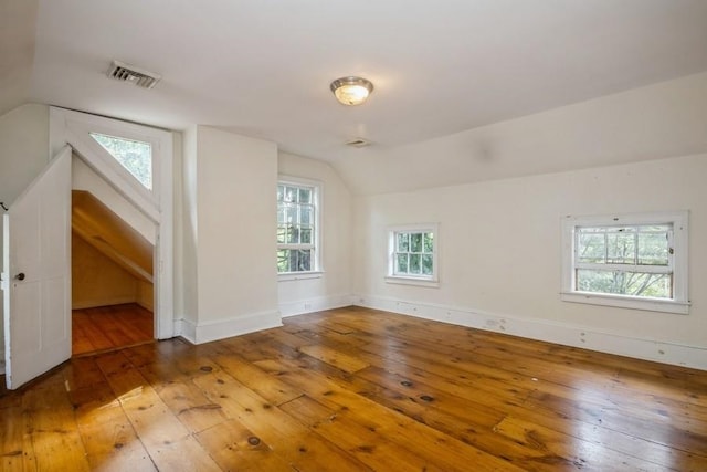 additional living space featuring hardwood / wood-style floors and vaulted ceiling