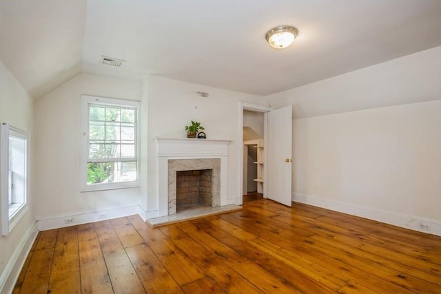 unfurnished living room with wood-type flooring and vaulted ceiling