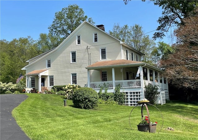 exterior space featuring a front lawn and covered porch