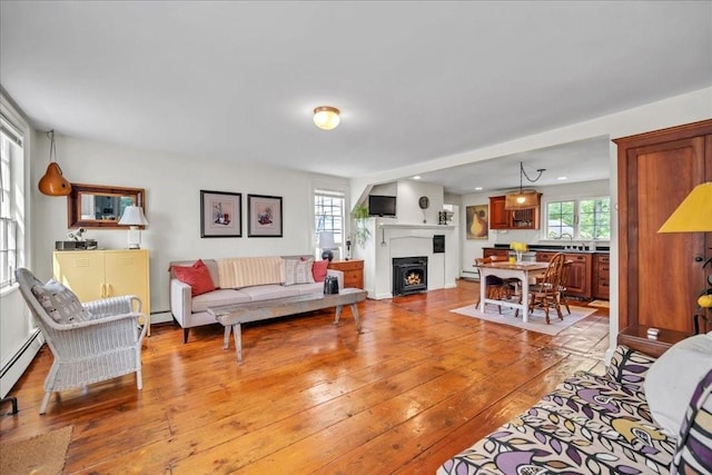 living room featuring light hardwood / wood-style flooring and baseboard heating