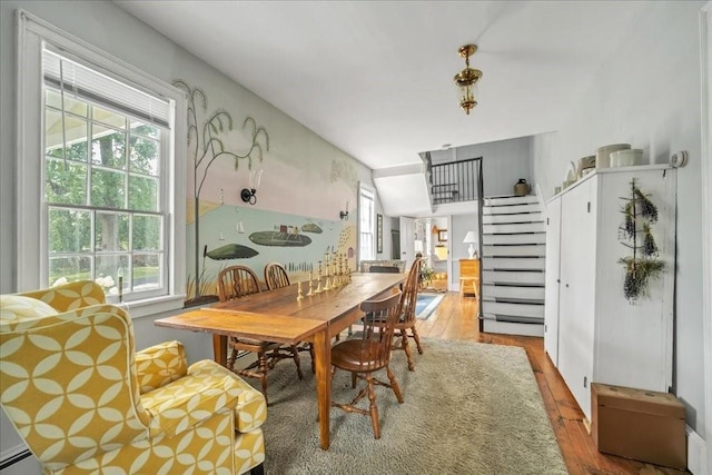 dining area featuring a baseboard radiator and light wood-type flooring