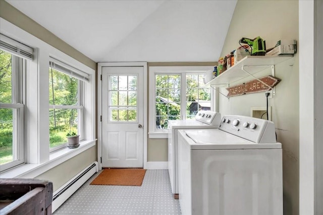 laundry area with washing machine and clothes dryer, a healthy amount of sunlight, and a baseboard radiator