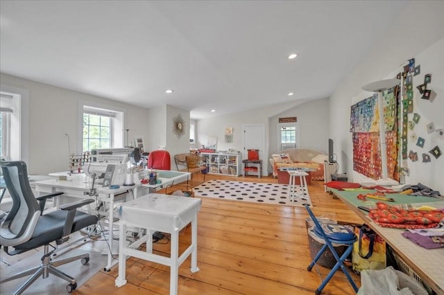 dining space with lofted ceiling and light hardwood / wood-style flooring