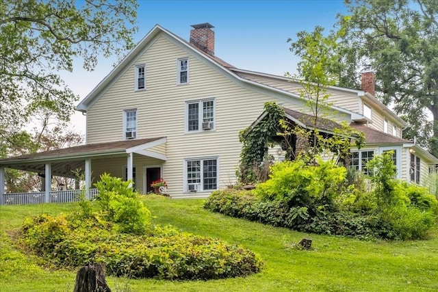 back of house featuring a yard