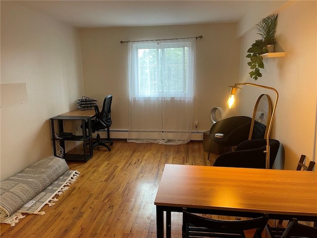 office featuring light hardwood / wood-style flooring and a baseboard heating unit