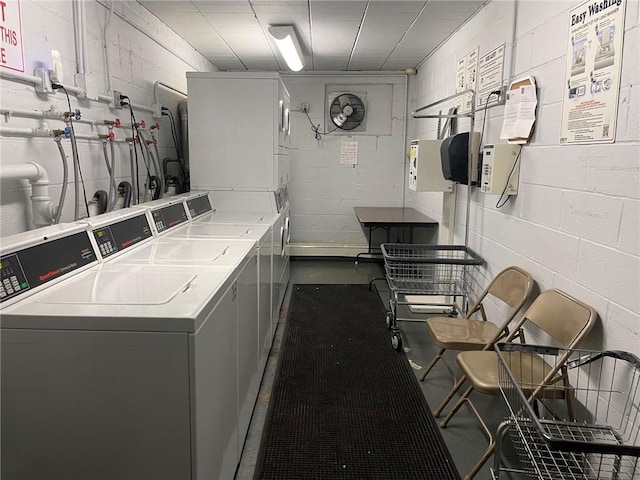 laundry room featuring stacked washer and clothes dryer and washing machine and clothes dryer