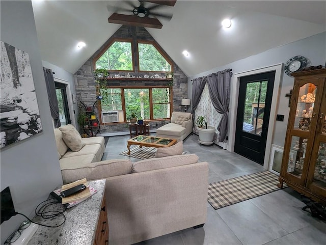 living room with plenty of natural light, ceiling fan, and high vaulted ceiling