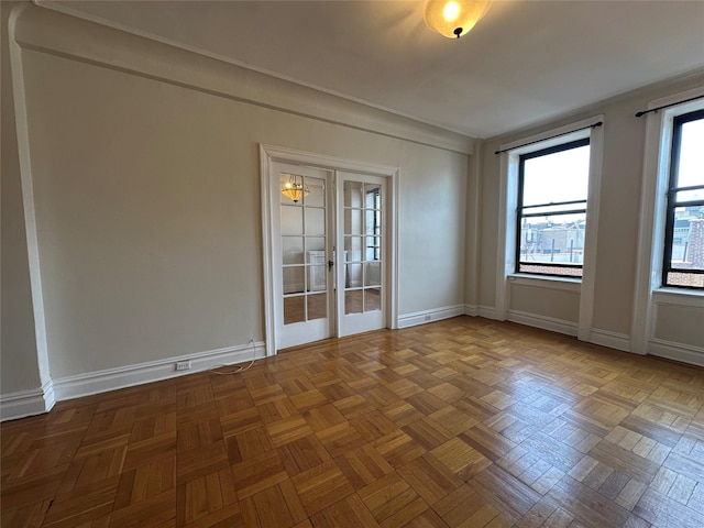 spare room featuring french doors and baseboards
