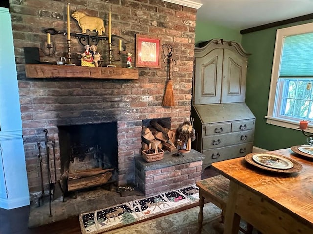 details featuring ornamental molding and a brick fireplace