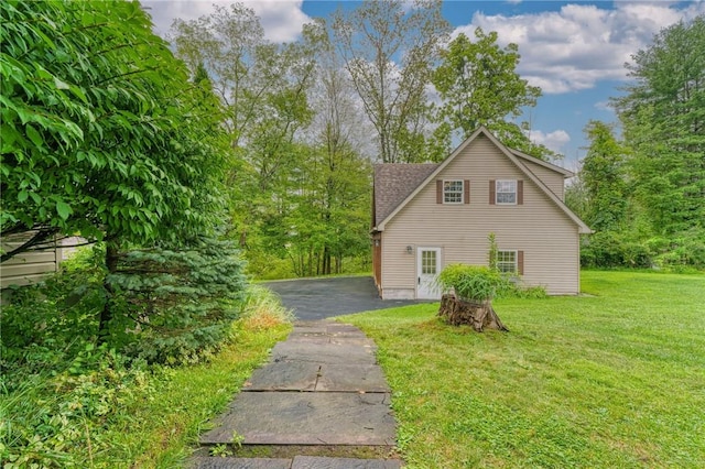 view of home's exterior with a lawn