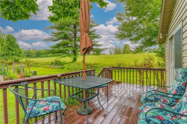 wooden deck with a yard and a rural view