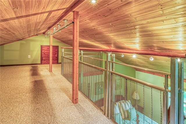 hall featuring vaulted ceiling with beams, carpet floors, and wooden ceiling