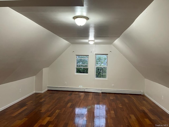 bonus room with a baseboard radiator, vaulted ceiling, and dark wood-type flooring