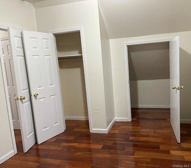 unfurnished bedroom with dark wood-type flooring