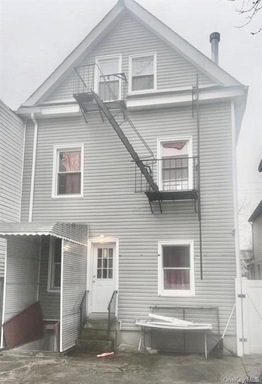 rear view of house featuring a balcony