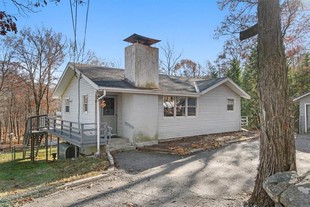 back of house featuring a wooden deck