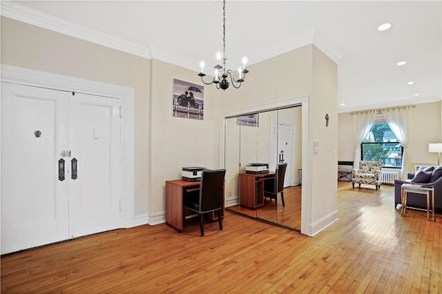 home office featuring light wood finished floors, ornamental molding, baseboards, and radiator