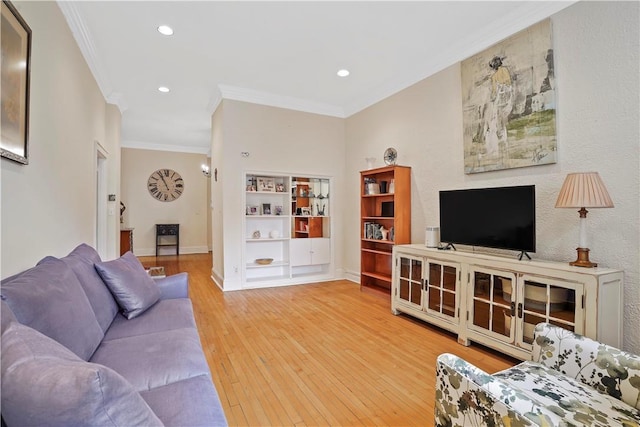 living room with ornamental molding, recessed lighting, baseboards, and light wood finished floors