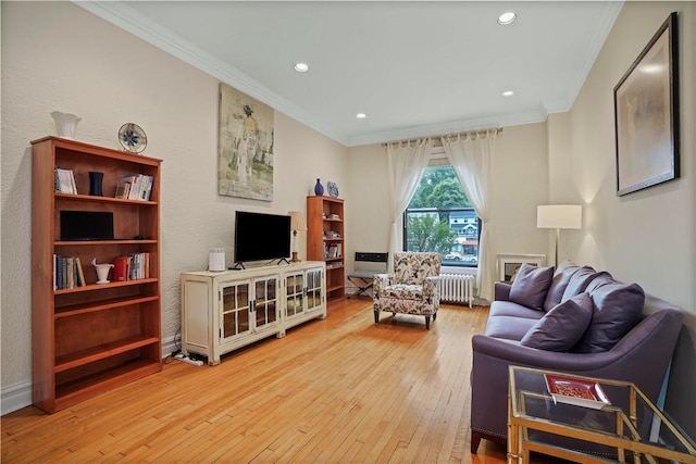 living area with crown molding, recessed lighting, hardwood / wood-style flooring, and radiator