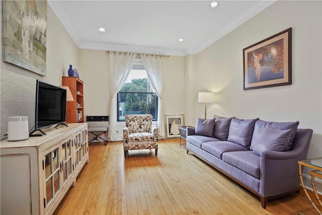 living room featuring light wood-style floors, recessed lighting, and ornamental molding